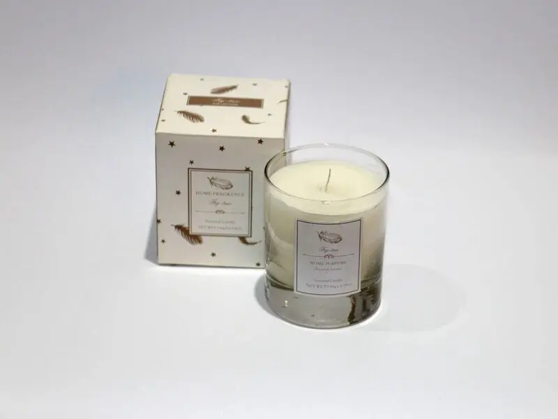 scented white candle in glass