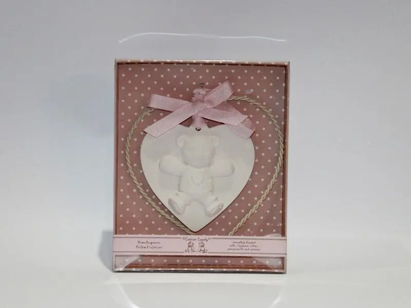 plaster teddy bear with metal heart