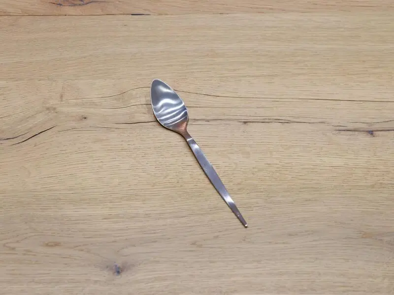 matte silver-colored stainless steel dessert spoon