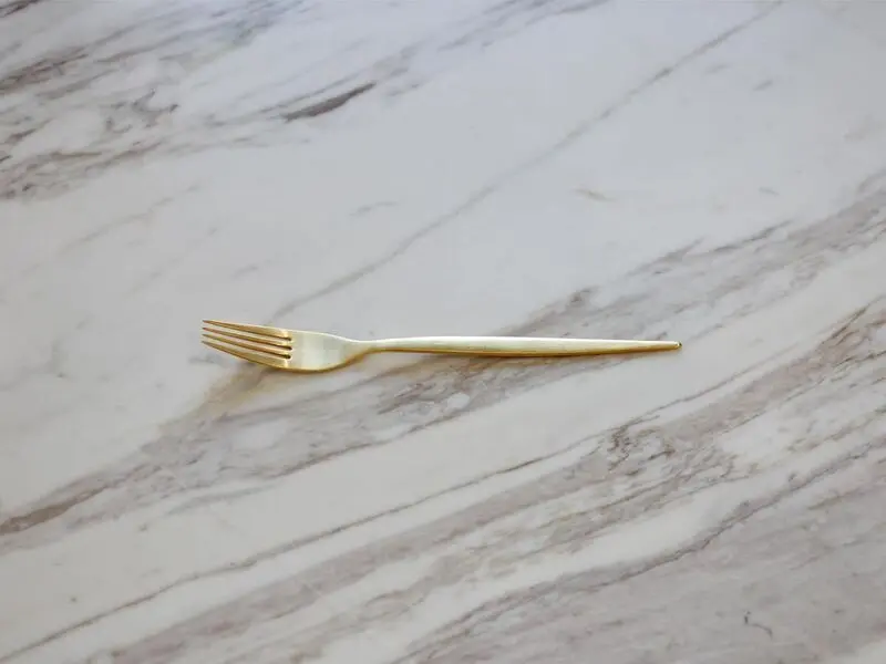 golden stainless steel dessert fork with matte finish