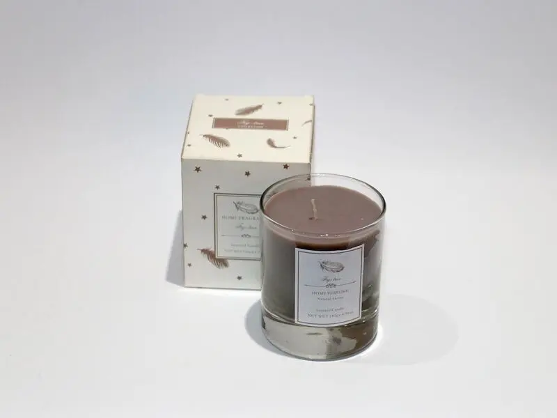scented brown candle in glass