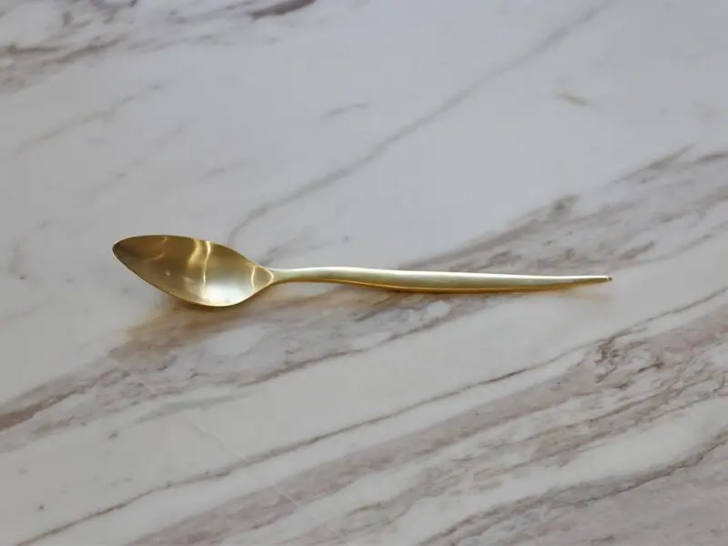 golden stainless steel dessert spoon with matte finish