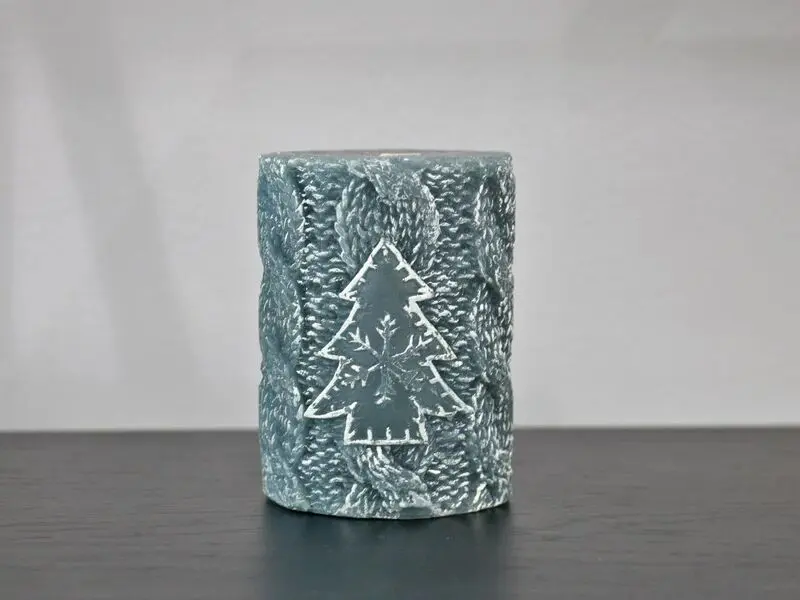 grey candle with christmas tree design