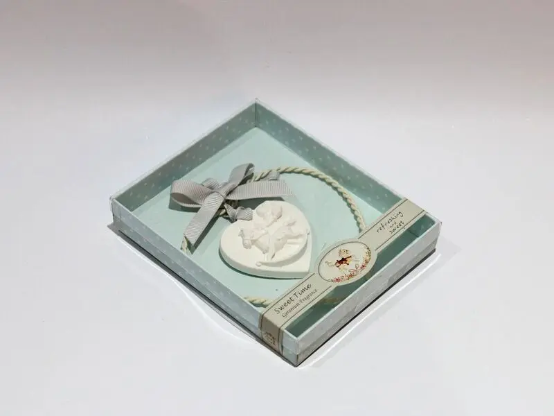 plaster horse with metal heart decoration