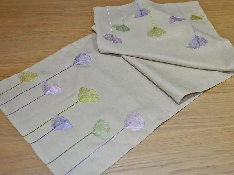 beige table runner with floral embroidery