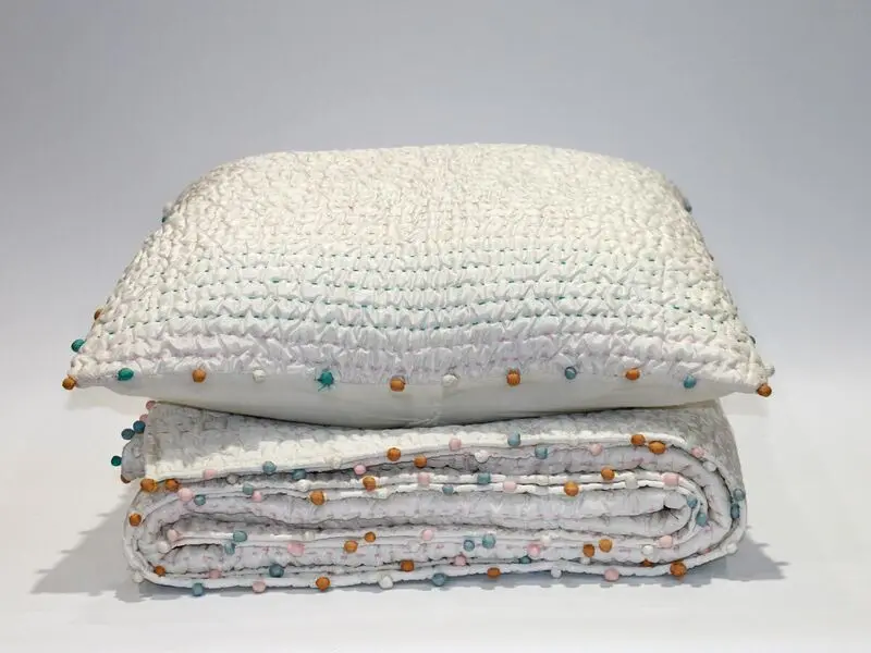 soft touch quilt with stitching details and pompoms170x220cm with one cushion cover