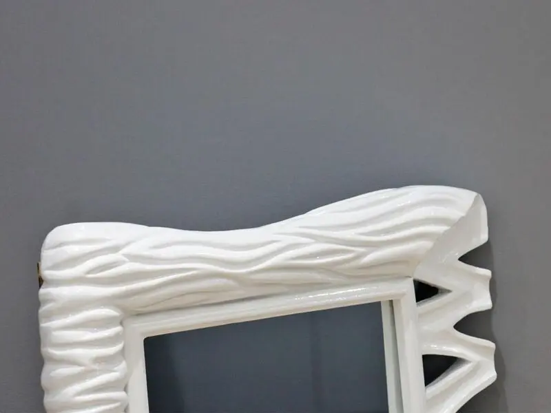 white frame mirror with wave design