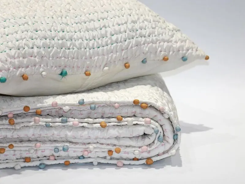 soft touch quilt with stitching details and pompoms170x220cm with one cushion cover