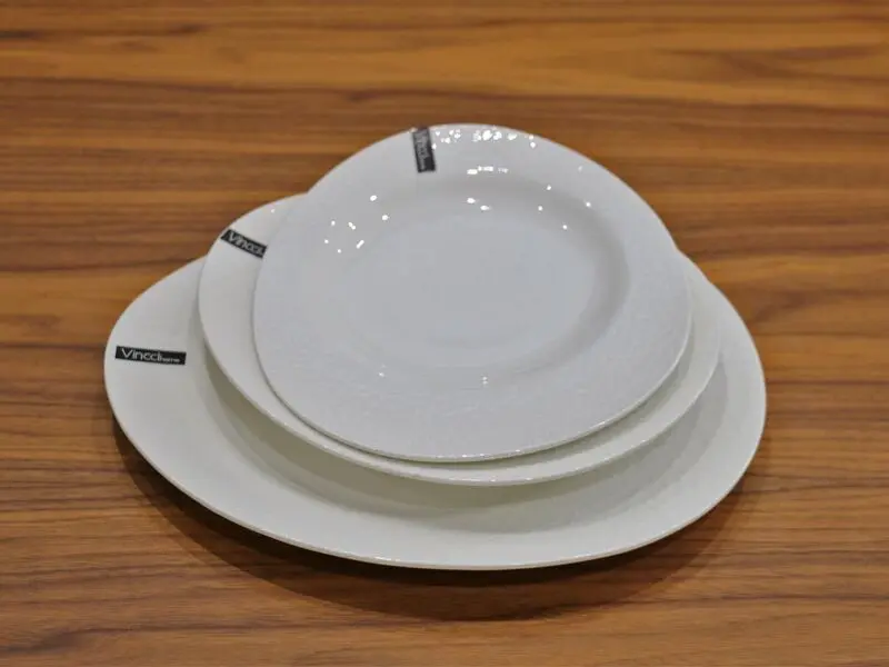 white glossy salad plate with raised design 21cm