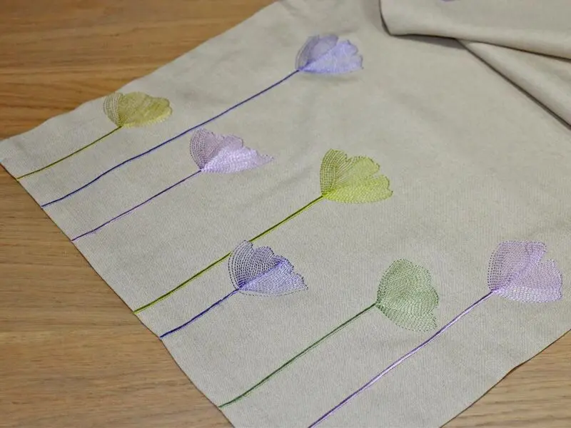 beige table runner with floral embroidery