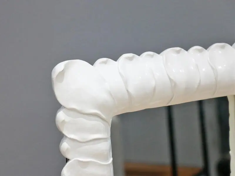 white frame mirror with petal design