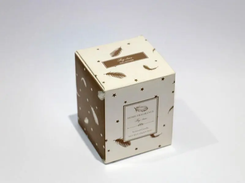 scented white candle in glass